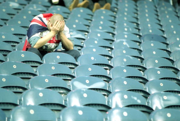 7 Nov 2000:  A dejected Glasgow Rangers fan after the UEFA Champions League match against Monaco at Ibrox in Glasgow, Scotland.  The match was draw...