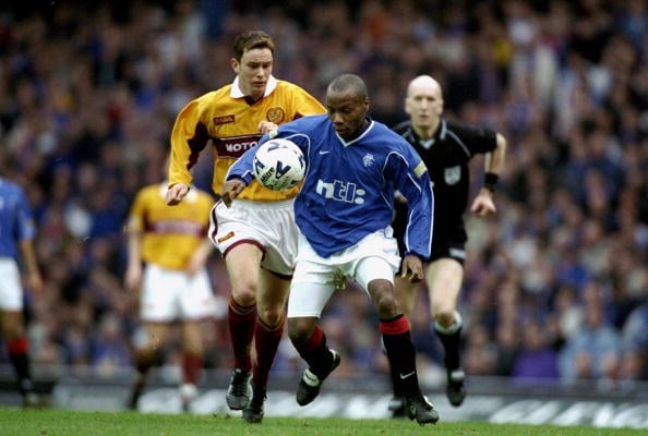 18 Mar 2000:  Rod Wallace of Glasgow Rangers shields the ball from Derek Adams of Motherwell during the Scottish Premier Division match at Ibrox St...