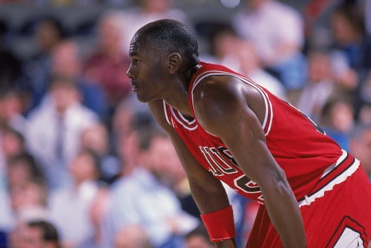 1988: Michael Jordan #23 of the Chicago Bulls rests on the court during a game. NOTE TO USER: User expressly acknowledges and agrees that, by downl...