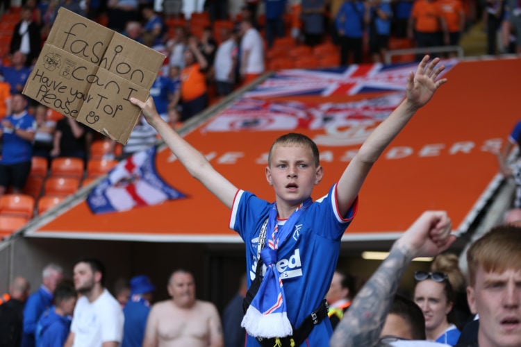 BLACKPOOL, ENGLAND - JULY 16: A young supporter of Rangers holds up a sign for Ranger's Fashion Sakala during the Pre-Season Friendly match between...