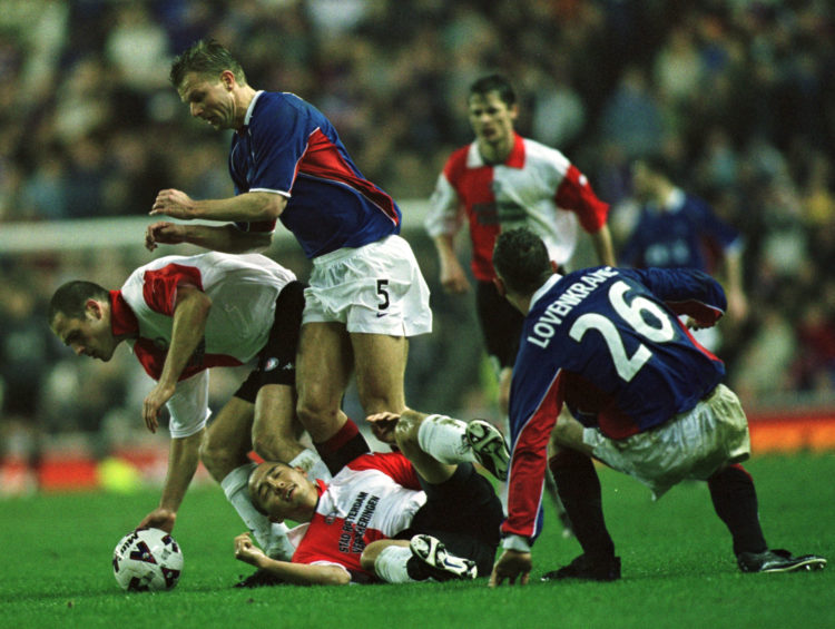 21 Feb 2002: Arthur Numan of Rangers battles with Shinji Ono of Feyenoord during the Glasgow Rangers v Feyenoord UEFA Cup fourth round, First leg ...