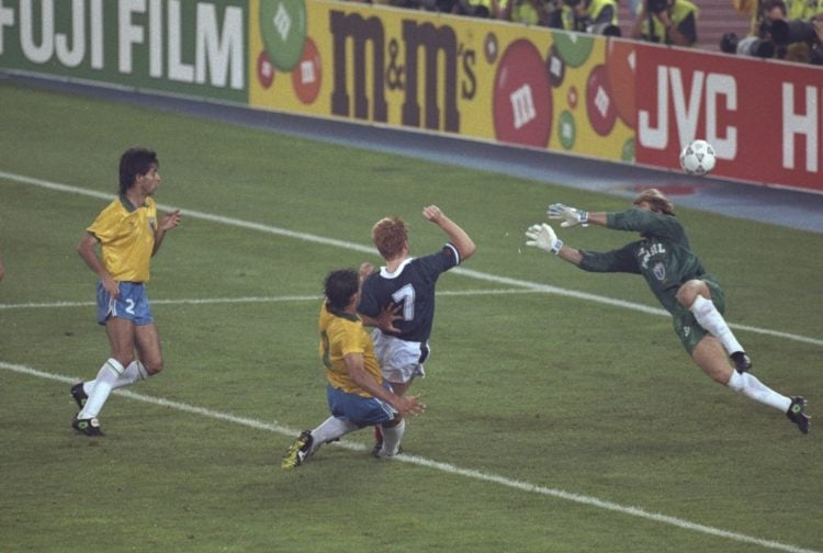 20 Jun 1990:  Mo Johnson (second right) of Scotland is tackled as he narrowly misses scoring in the closing stages during the World Cup match again...