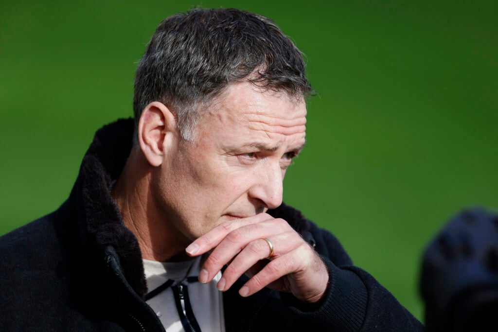 Chris Sutton looks on.